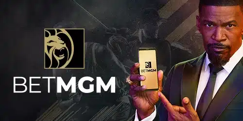 BetMGM advertisement with Jamie Foxx holding a smartphone displaying the BetMGM app. The BetMGM logo is also shown
